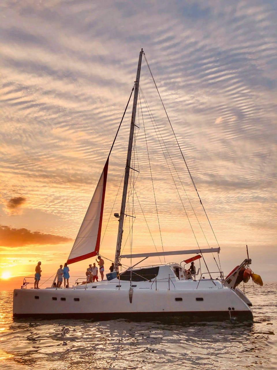 Sunset catamaran sailing Papagayo Bay with guests aboard